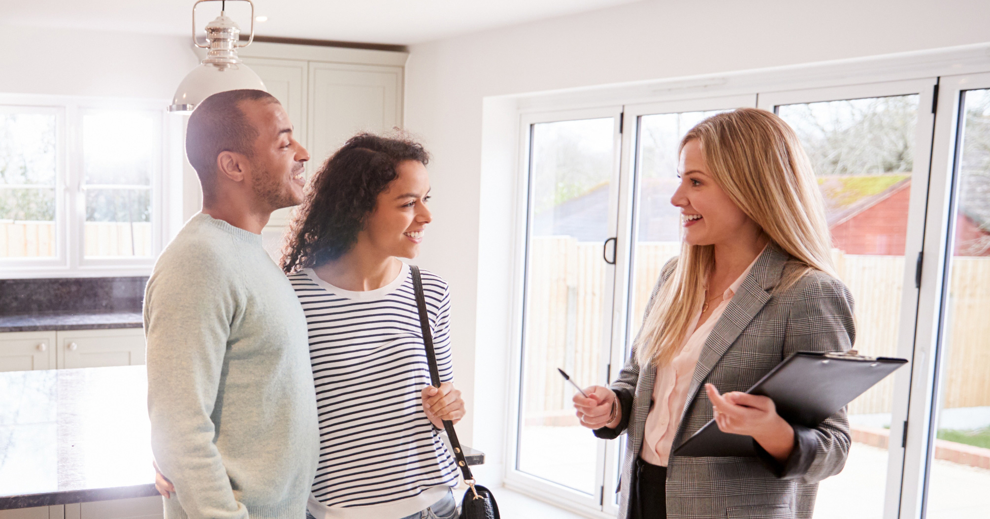 sales rep viewing house with couple